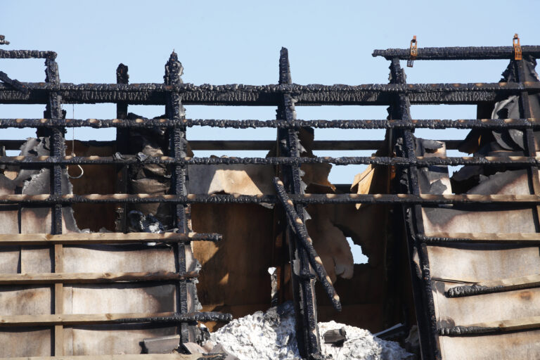 Closeup shot of a burned-out attic of a house after fire damage in Germany; sky background